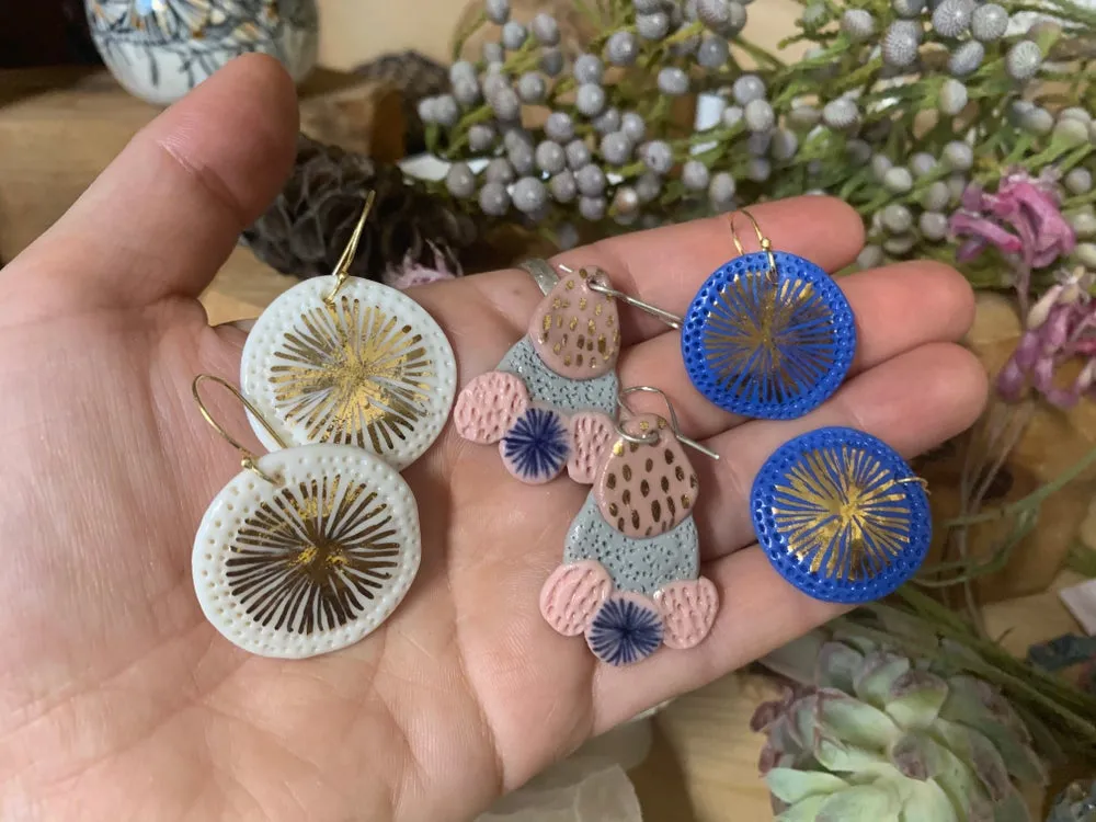 Coloured porcelain earrings, with painted lustre details.